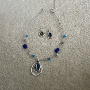 Silver colored necklace with blue and green stone and matching earrings